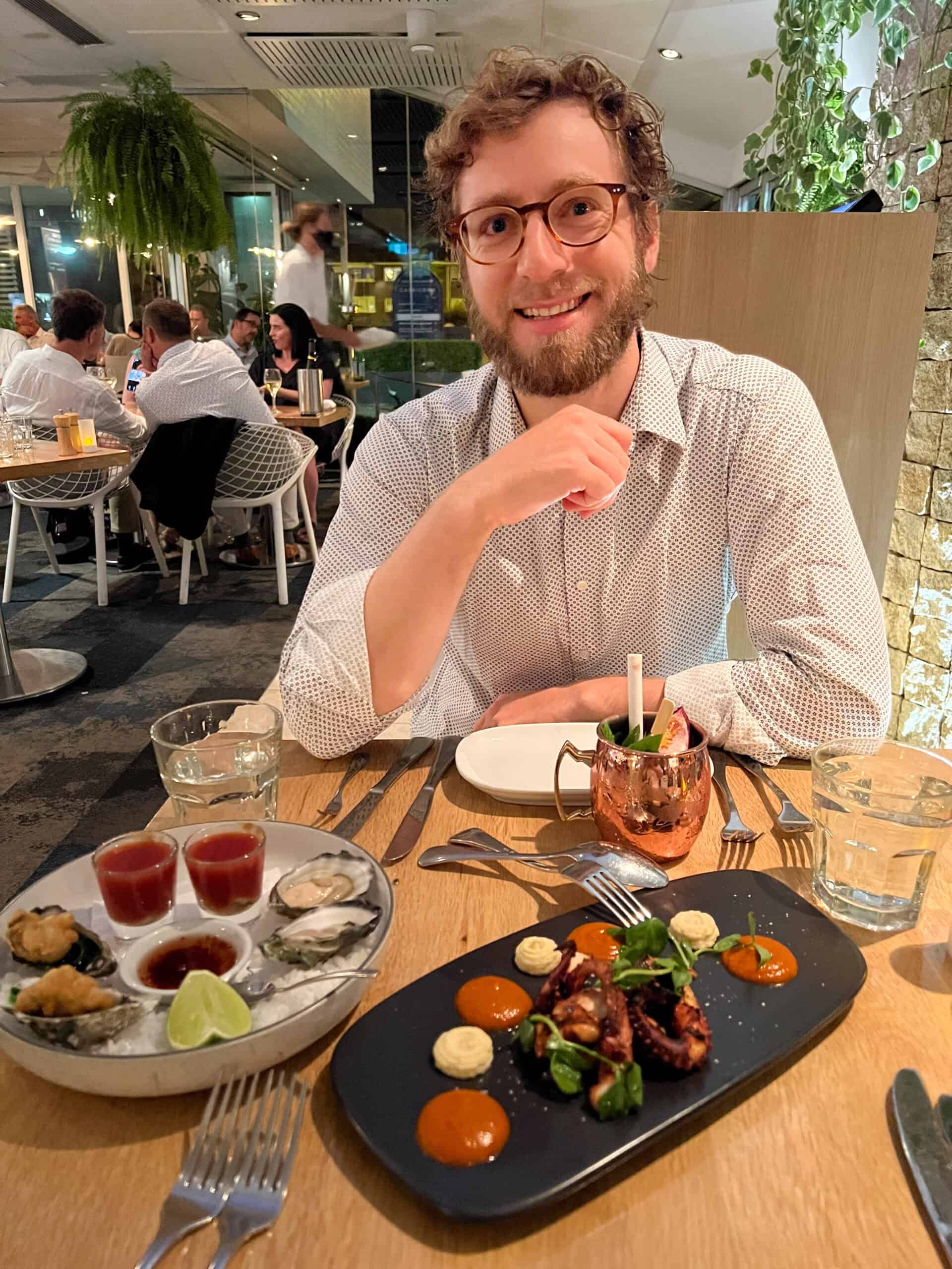 A man enjoying seafood at a restaurant in Sydney