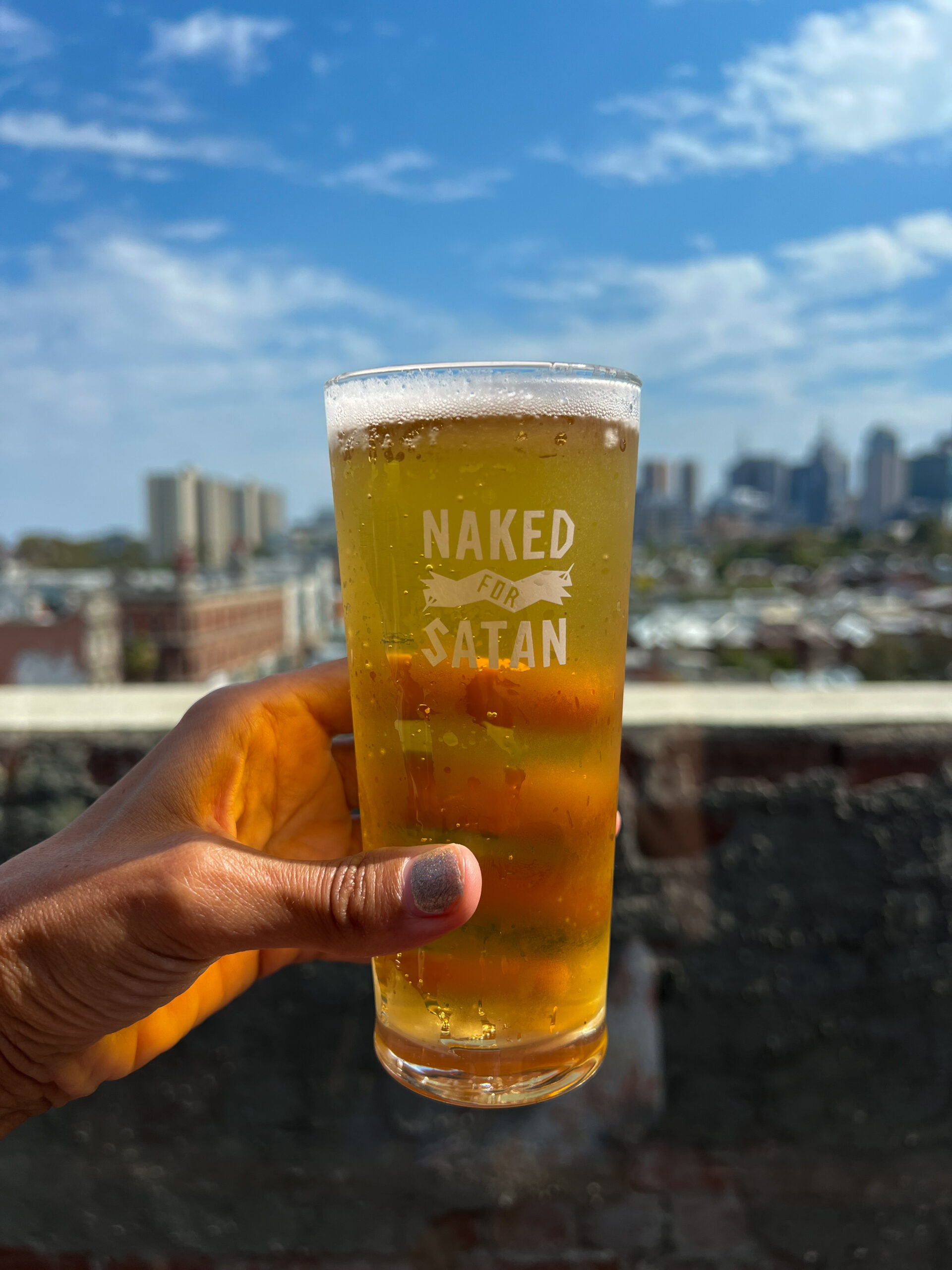 A beer from the rooftop bar Naked for Satan