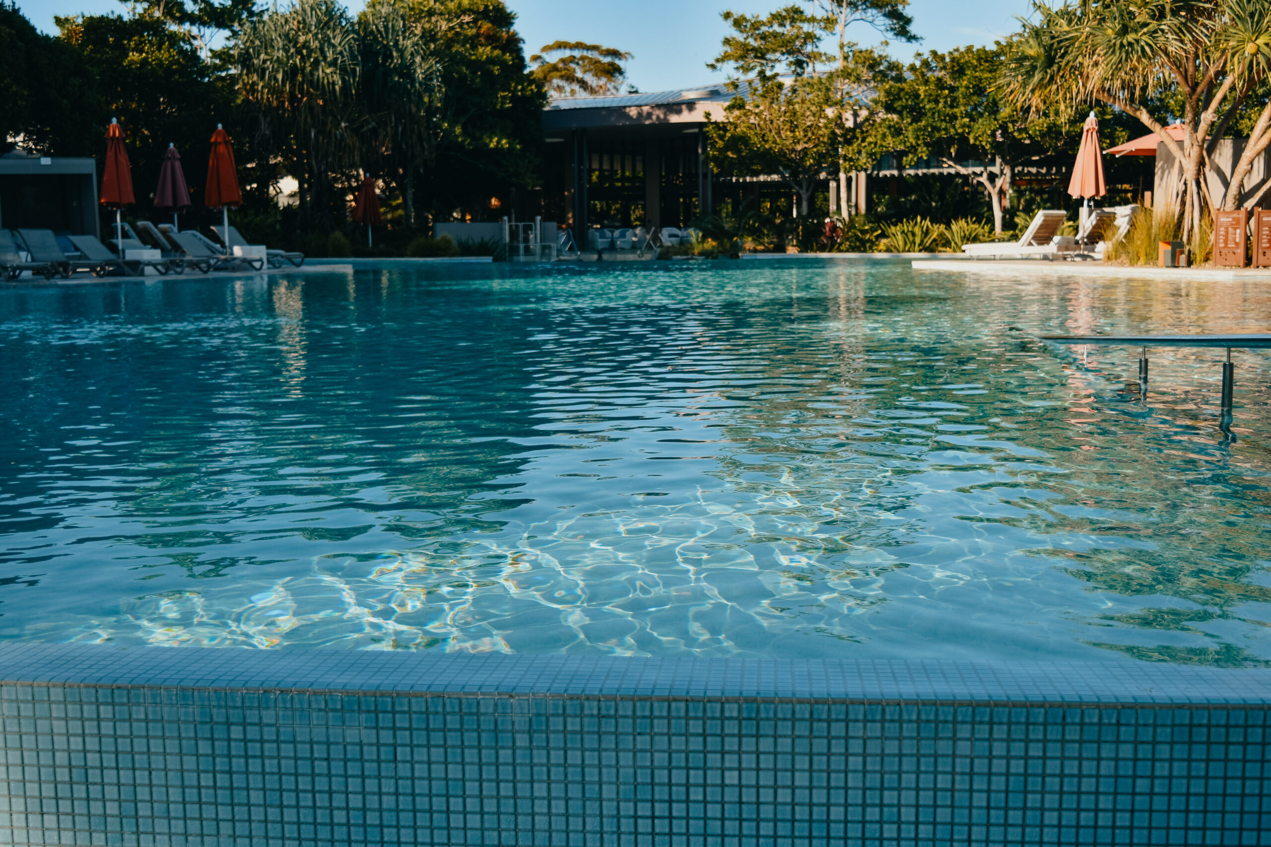 A large, lagoon-style swimming pool with turquoise water.