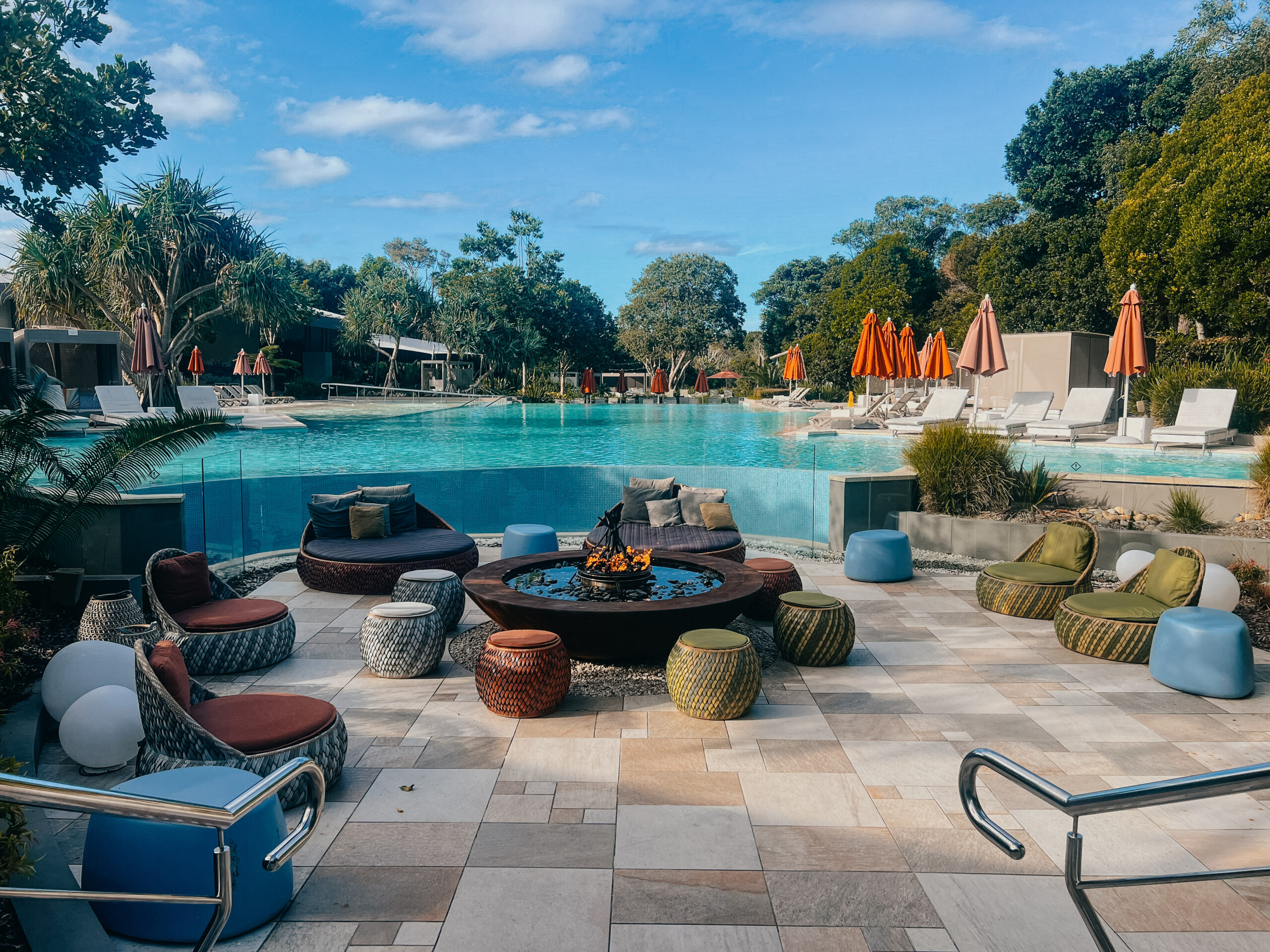 Elements of Byron lagoon pool with a fire pit in front 