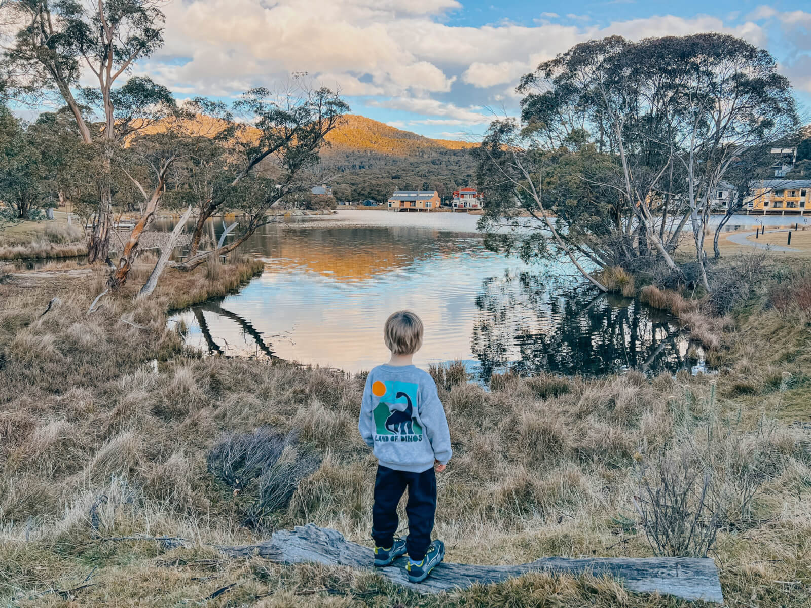A toddler looking over Lake Crackenback